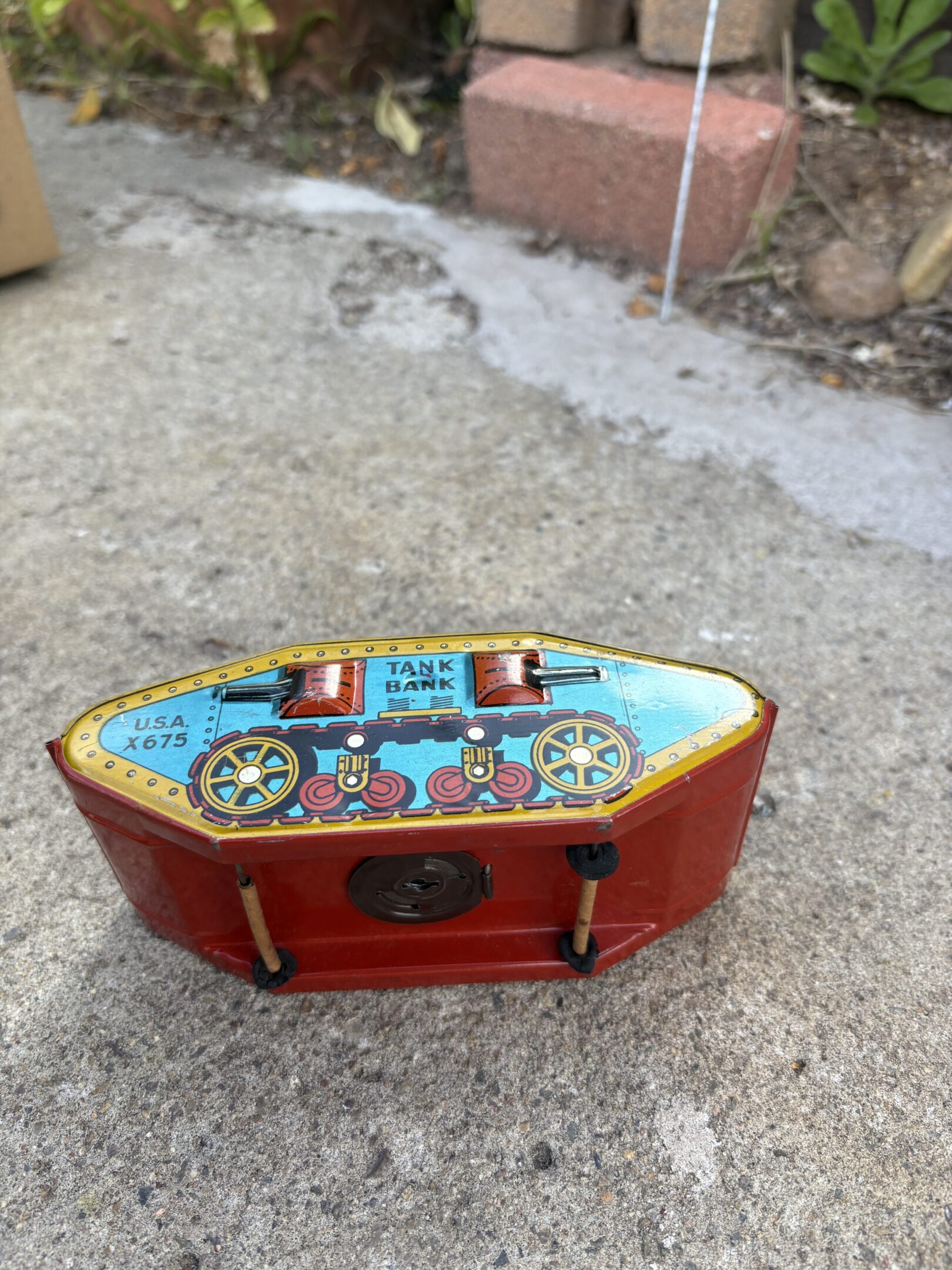 Vintage red boat-shaped jewelry box with colorful inlay designs.