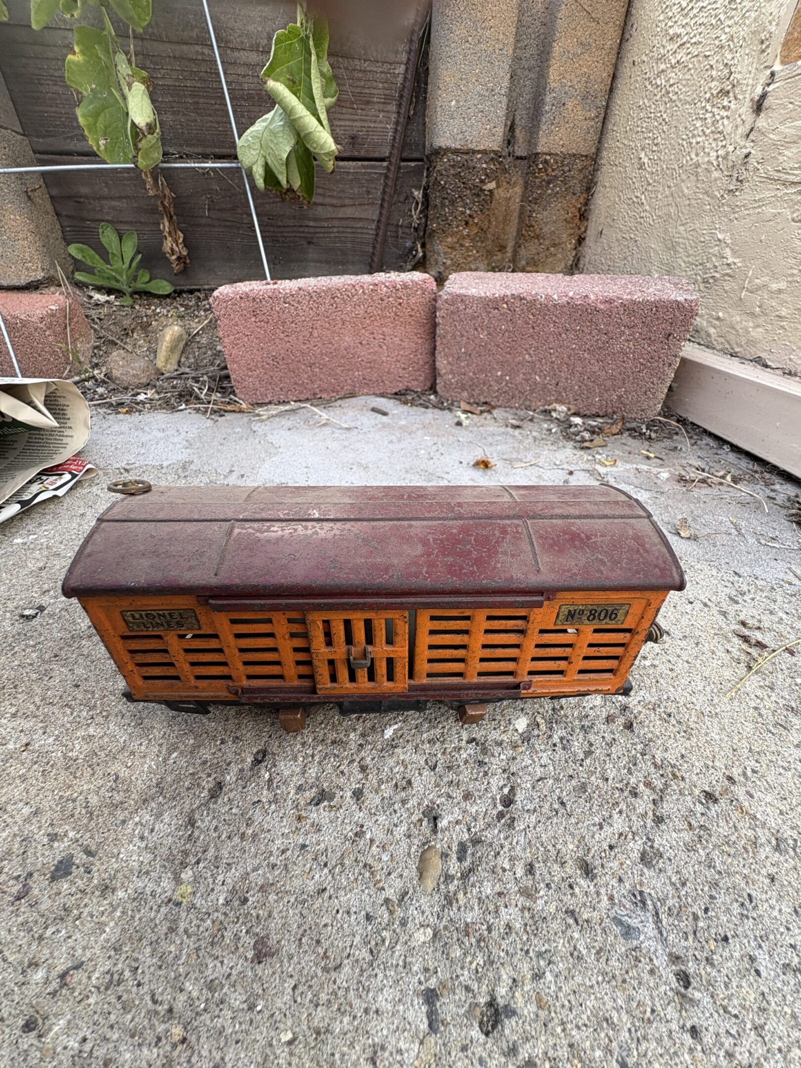 Vintage wooden radio with a classic design sitting outdoors.