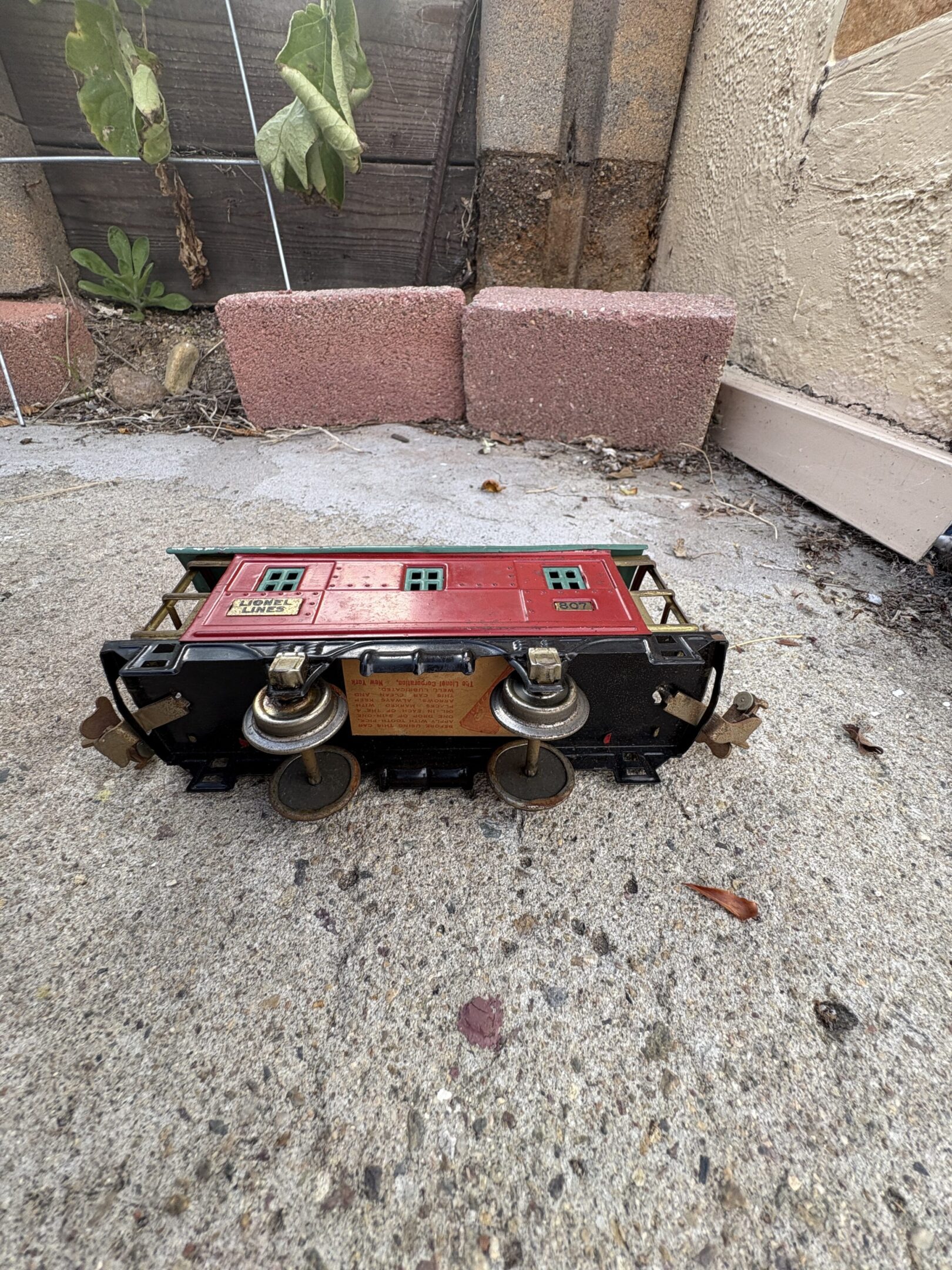 Vintage mechanical counter device with dials and buttons on concrete ground.