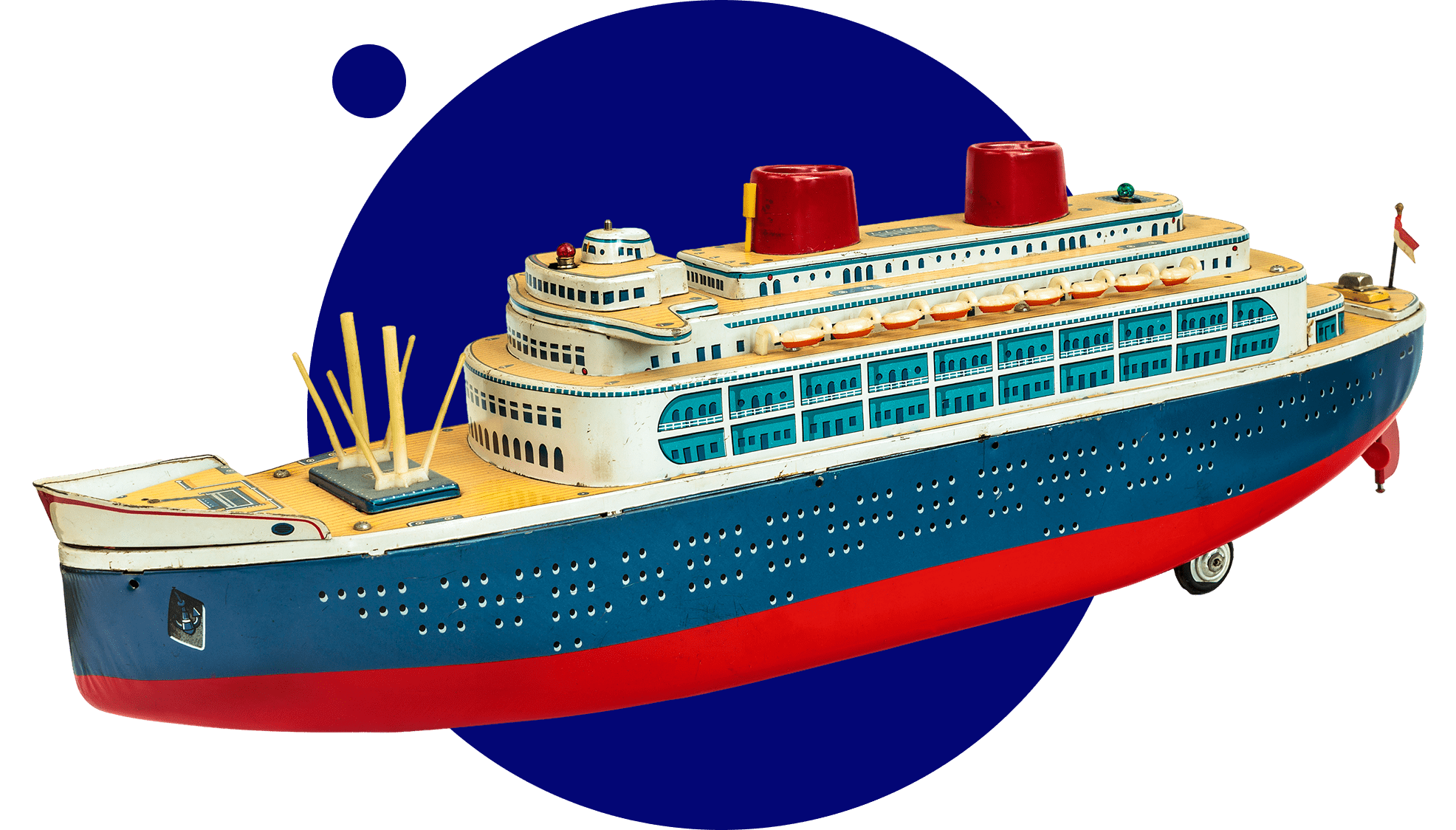 A detailed model of a cruise ship with lifeboats and red funnels.