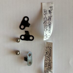 Three small metal parts with handwritten labels on a white background.