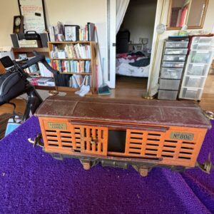 Vintage wooden radio with intricate design on a purple carpet.