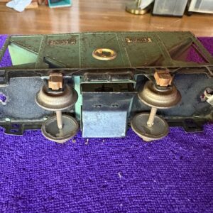 Vintage balance scale with brass weights on a purple surface.
