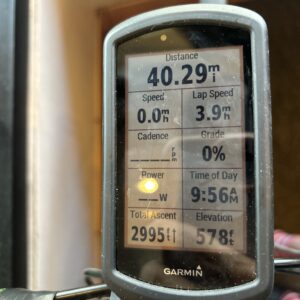 Garmin watch showing cycling stats including distance, speed, and calories.