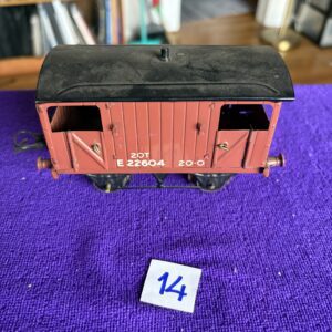 Vintage model train boxcar on a purple cloth with number 14.