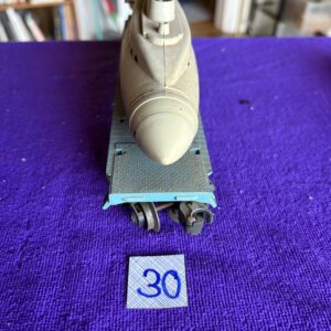 A close-up of a model airplane nose on a stand with a blue number 30 tag.