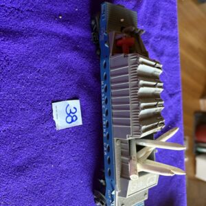 Set of metal drill bits arranged on a purple cloth.