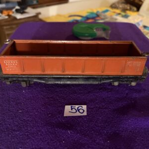 Vintage model train freight car on a purple surface with number 56.