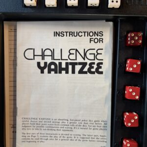 Instruction booklet for Challenge Yahtzee game with dice on the side.
