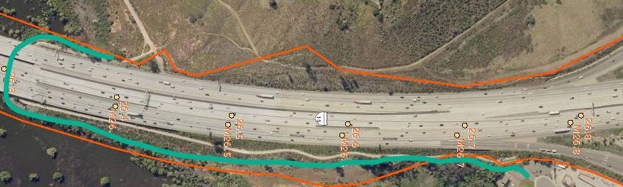 Aerial view of a highway with vehicles and marked boundaries.