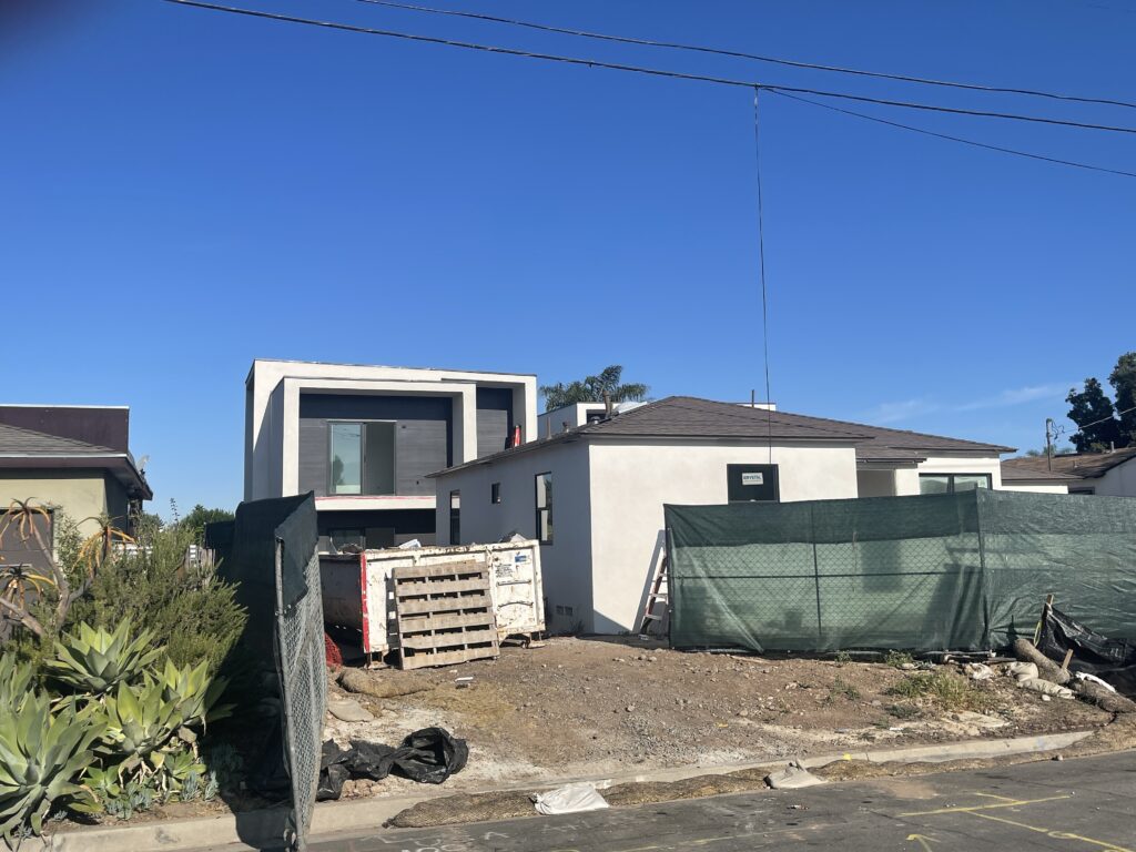 A modern house under construction with clear blue sky.