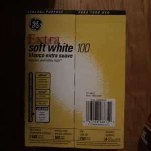 Bar of Soft White Extra Soap with yellow packaging on wood surface.