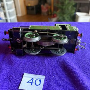 Model train car viewed upside down showing wheel assembly.