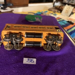 A detailed model of a wooden train car on a purple surface.