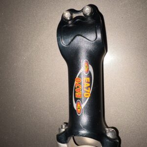 Black bicycle stem with colorful central logo on a gray surface.