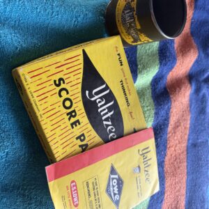 Vintage yellow packaging of Walker's Score and another product on a colorful towel.